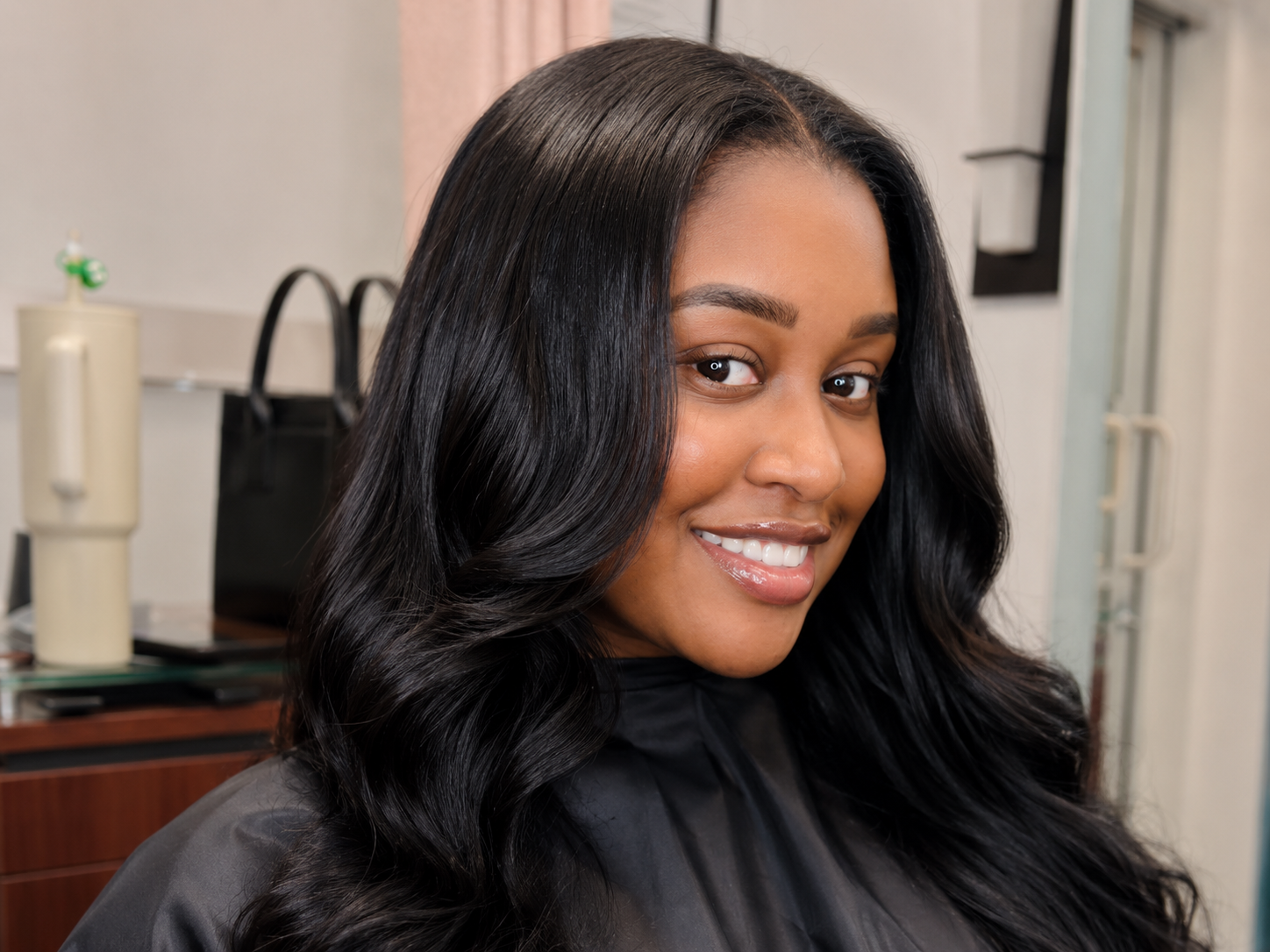 K-tip client smiling with long flowing black waves
