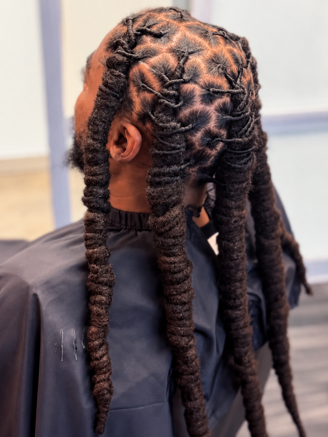 Freshly retwisted locs styled into thick barrel twists