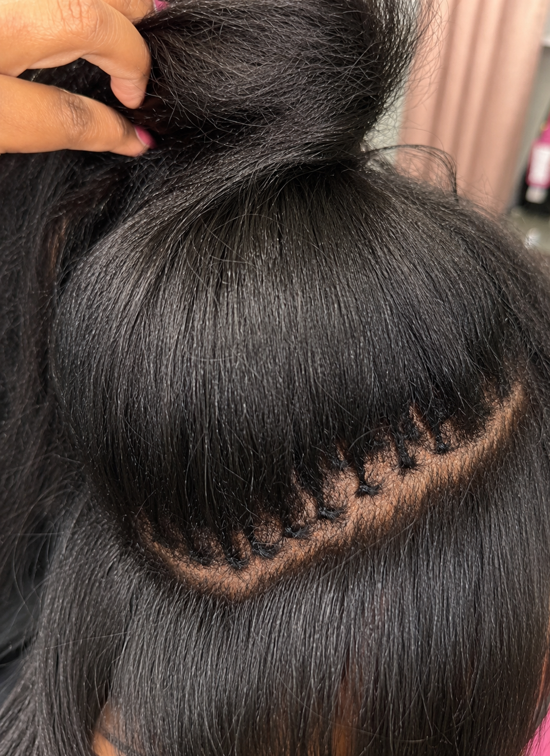Close-up of K-tip bonds blended into a sleek high ponytail