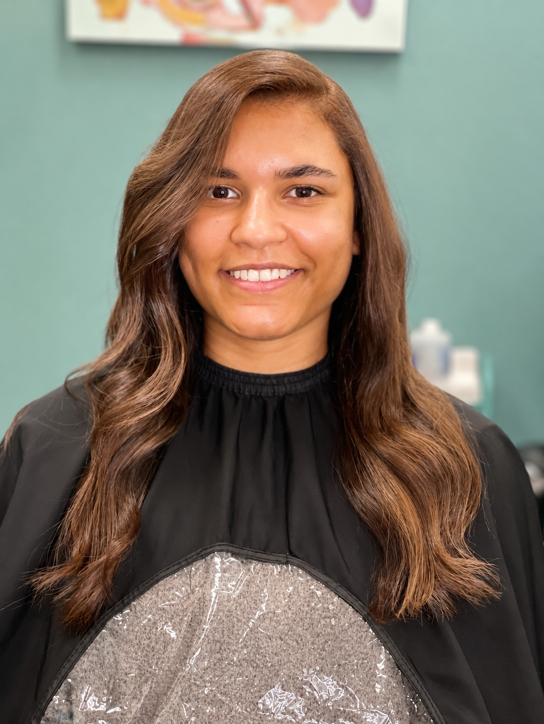Warm caramel balayage with soft flowing waves and luminous shine